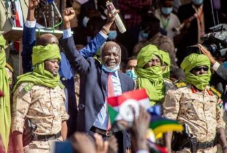 Gibril Ibrahim greets his supporters after his return to Khartoum on November 15 2021
