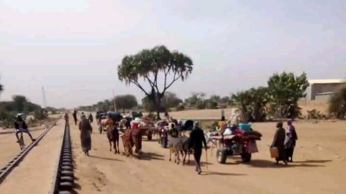 Civilians fleeing Babanosa walking alongside the railway on January 27 2024