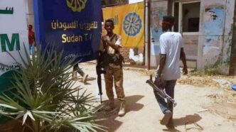 Sudanese army soldiers pose outside the entrance of the Sudan TV station on March 12 2024 1