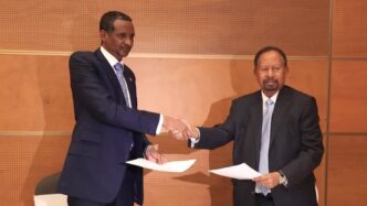 Tagadum chair Hamdok and RSF leader Hemetti exchange the signed copy of the Addus Ababa Declaration on January 2 2024