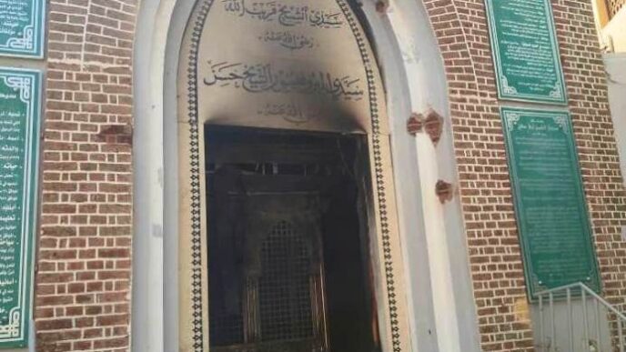 The damaged entrance of the site housing the grave of the late Sufi leader Sheikh Hassan Al Fatih Qaribullah at his mosque in Omdurmans Wad Nubawi neighbourhood