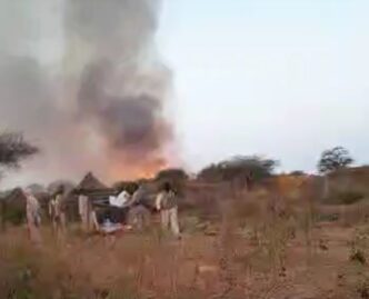 RSF elements watch a burning village empty of its residents who fled the area in a video released on December 25 2022