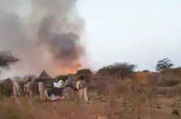 RSF elements watch a burning village empty of its residents who fled the area in a video released on December 25 2022